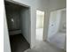 Hallway with view into tiled bathroom and additional bedrooms, offering a glimpse of the home's layout at 333 Trailmore Ln, Summerville, SC 29486