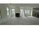 Open living room with a cozy fireplace and large windows for ample natural light at 333 Trailmore Ln, Summerville, SC 29486