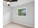 Comfortable bedroom featuring a ceiling fan, tiled floors, and a bright, sunlit window at 40 Elmwood Pl, Goose Creek, SC 29445