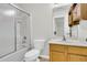Well-lit bathroom featuring a shower with sliding glass doors and a classic wood vanity with a white countertop at 423 Watershed Dr, Goose Creek, SC 29445