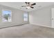 Spacious bedroom boasts neutral walls, carpet flooring, and large windows offering picturesque neighborhood views at 423 Watershed Dr, Goose Creek, SC 29445