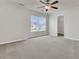 Light-filled bedroom with soft carpeting, closet, and a large window providing views of the landscaped yard at 423 Watershed Dr, Goose Creek, SC 29445