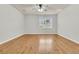 Cozy bedroom featuring hardwood floors, a ceiling fan, and a window for natural light at 423 Watershed Dr, Goose Creek, SC 29445