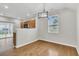 Bright dining area with hardwood floors, a modern chandelier, and views of the backyard at 423 Watershed Dr, Goose Creek, SC 29445
