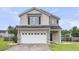 Inviting two-story home with neutral siding, a two-car garage, and well-maintained landscaping at 423 Watershed Dr, Goose Creek, SC 29445