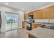 Functional kitchen featuring wood cabinets, modern appliances, and access to the outdoor patio area at 423 Watershed Dr, Goose Creek, SC 29445