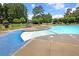 Community pool with zero entry featuring lounge chairs, tables and umbrellas at 423 Watershed Dr, Goose Creek, SC 29445