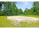 Community sand volleyball court surrounded by green grass and mature trees at 423 Watershed Dr, Goose Creek, SC 29445