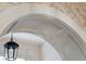 Close-up of an elegantly trimmed archway with custom details and a vintage-style pendant light at 43 Hasell St, Charleston, SC 29401