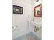 Modern powder room with a sleek sink, a framed mirror, and a calming blue accent color at 43 Hasell St, Charleston, SC 29401