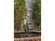 Ornate fountain with a bronze statue set among lush greenery and a brick border at 43 Hasell St, Charleston, SC 29401
