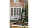 Charming fountain with a statue surrounded by a brick border, greenery, and a lounging area at 43 Hasell St, Charleston, SC 29401