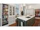 Kitchen view with a large island, marble countertops, and built-in bookcase at 43 Hasell St, Charleston, SC 29401