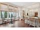 A sunny kitchen with breakfast nook featuring large windows and views to a lush green backyard at 43 Hasell St, Charleston, SC 29401