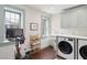 Functional laundry room featuring a washer, dryer, sink, cabinets, and a sleek exercise bike at 43 Hasell St, Charleston, SC 29401