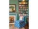 Cozy living room featuring a fireplace, bookshelves, and a comfortable patterned chair at 43 Hasell St, Charleston, SC 29401
