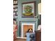 Living room fireplace with decorative mantle, painting, and a comfortable chair at 43 Hasell St, Charleston, SC 29401