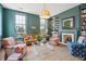 Bright living room featuring colorful seating, built-in bookshelves, and a decorative fireplace at 43 Hasell St, Charleston, SC 29401