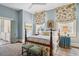 Comfortable main bedroom with windows, a four-poster bed and an adjoining bathroom at 43 Hasell St, Charleston, SC 29401