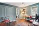Stylish home office featuring natural light, built-in shelves, a desk and a doorway to an adjacent bathroom at 43 Hasell St, Charleston, SC 29401