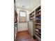 Organized walk-in closet with built-in shelves, drawers, and wooden flooring at 43 Hasell St, Charleston, SC 29401
