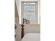 Bright bedroom window with natural light and a charming view of brick, complemented by a selection of books at 43 Hasell St, Charleston, SC 29401
