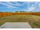 View of a spacious backyard with a wooden fence and a concrete patio area at 430 Pender Woods Dr, Summerville, SC 29486