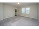 Bedroom with neutral carpet, two windows, and view of bathroom at 430 Pender Woods Dr, Summerville, SC 29486