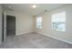 Bright bedroom with neutral paint, plush carpeting, and natural light from two windows at 430 Pender Woods Dr, Summerville, SC 29486