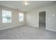 Bedroom featuring neutral carpet, two windows, and a connecting door to the next room at 430 Pender Woods Dr, Summerville, SC 29486