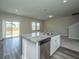Kitchen island with granite countertops and stainless steel dishwasher in new home at 430 Pender Woods Dr, Summerville, SC 29486
