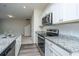 Kitchen with granite countertops and stainless appliances open to living area at 430 Pender Woods Dr, Summerville, SC 29486