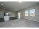 Open-concept living room with carpet, wood-look flooring and abundant natural light at 430 Pender Woods Dr, Summerville, SC 29486