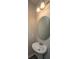 Cozy powder room featuring a pedestal sink, round mirror, and decorative lighting at 430 Pender Woods Dr, Summerville, SC 29486