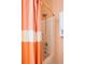 Bathroom with shower-tub combo featuring a patterned orange and white shower curtain at 4621 Holmes Ave, North Charleston, SC 29405