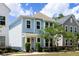 Side view of a two-story home with light blue siding, a tan roof, and lush landscaping at 4621 Holmes Ave, North Charleston, SC 29405