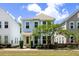 Charming two-story home with light blue siding, manicured landscaping, and a welcoming yellow front door at 4621 Holmes Ave, North Charleston, SC 29405