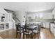 Bright kitchen features white cabinets, stainless steel appliances, island with bar seating, and dining area at 4621 Holmes Ave, North Charleston, SC 29405