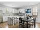 Bright, open kitchen featuring white cabinets, stainless steel appliances, and a dining area at 4621 Holmes Ave, North Charleston, SC 29405
