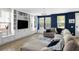 Spacious living room featuring custom built-ins, large windows, and a comfortable sectional sofa at 4621 Holmes Ave, North Charleston, SC 29405