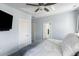 Bright main bedroom features blue walls, carpet floors, ceiling fan, and view to the en-suite bathroom at 4621 Holmes Ave, North Charleston, SC 29405