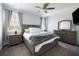Spacious main bedroom features a ceiling fan, carpet floors, large bed, and a dresser with a mirror at 4621 Holmes Ave, North Charleston, SC 29405
