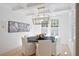 Elegant dining room with coffered ceiling, modern chandelier, and natural light at 477 Yellow House Pl, Charleston, SC 29492