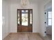 Foyer with wood door and flooring, board and batten, and open concept to the other rooms at 477 Yellow House Pl, Charleston, SC 29492