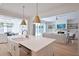 Open-concept kitchen with quartz countertops and stainless steel appliances, with view to the living room at 477 Yellow House Pl, Charleston, SC 29492