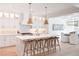 Gourmet kitchen boasts a large center island with seating, modern lighting, and stainless steel appliances at 477 Yellow House Pl, Charleston, SC 29492