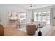 Bright living room features a ceiling fan and opens to kitchen with a view to backyard at 477 Yellow House Pl, Charleston, SC 29492
