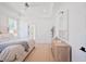 Bright and airy main bedroom with tray ceiling, hardwood floors and a view to the ensuite bathroom at 477 Yellow House Pl, Charleston, SC 29492