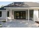 Covered patio with neutral colored pavers leads to double sliding doors into the living room at 477 Yellow House Pl, Charleston, SC 29492