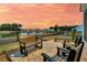 Back patio with comfortable seating overlooking a tranquil lake at 511 Ocean Mist Way, Summerville, SC 29486